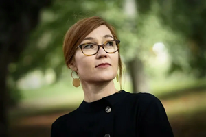 Professional headshot of Lagerkvist against forest background